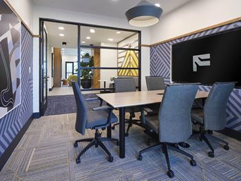 a conference room with a table and chairs